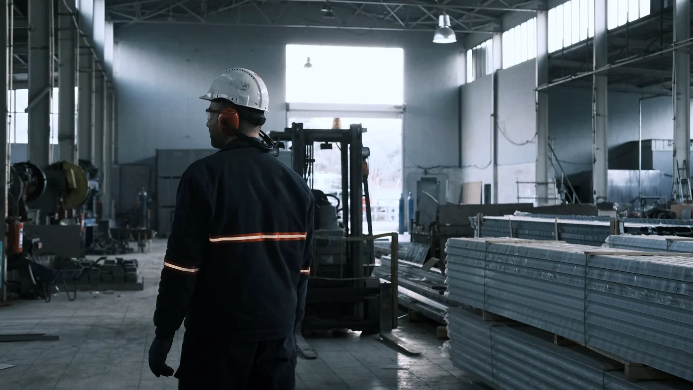A worker on the production floor of an EU manufacturing facility