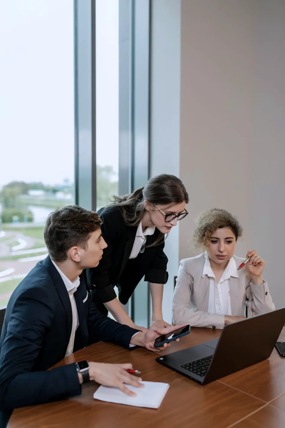 A team reviewing sourcing terms on a laptop